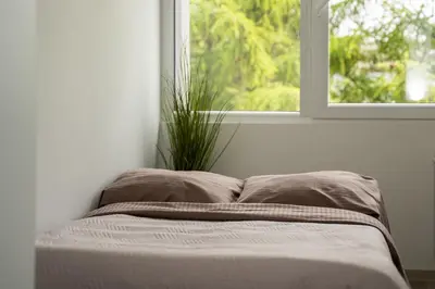 a bed in a room with a window at Nordic Studio In Prime Vilnius Location in Vilnius