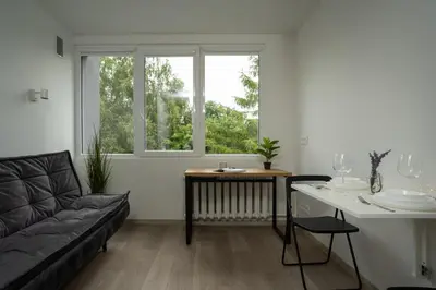 a living room with a couch and a table at Nordic Studio In Prime Vilnius Location in Vilnius