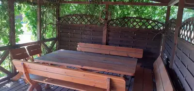 a wooden bench sitting on top of a brick wall at Vila Mera in Pabradė