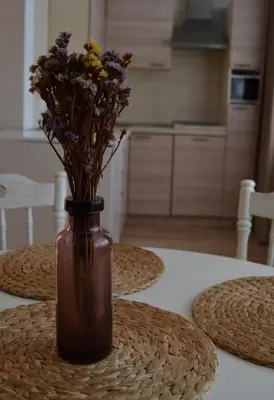 a vase with flowers in it sitting on a table at Šaulys in Druskininkai