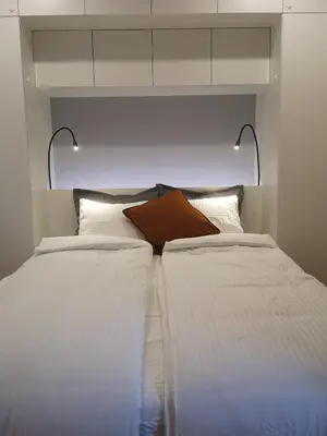 a bedroom with two beds with white sheets at Parko rezidencija apartments - SELF CHECK-IN in Panevėžys