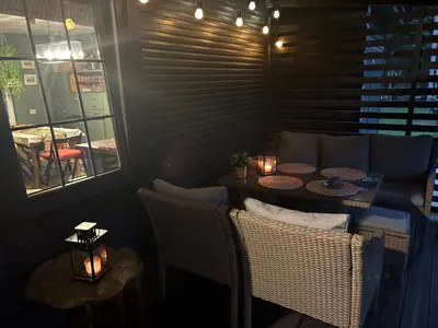 a room with a table and chairs and a window at Sodyba ramiam poilsiui in Kaltanėnai