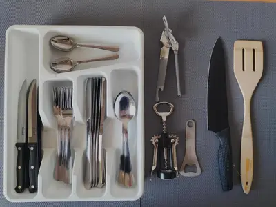 a white tray filled with utensils on a table at Rokiskis- jaukus butas su balkonu in Rokiškis