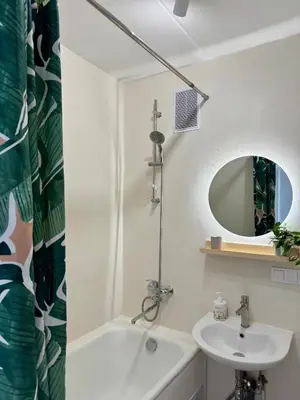 a white bathroom with a sink and a mirror at Rokiskis- jaukus butas su balkonu in Rokiškis