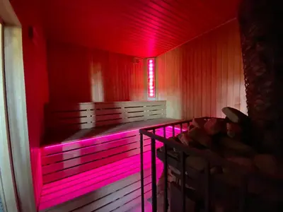 a room with a bed with pink lights in it at Pirties namelis in Girininkai