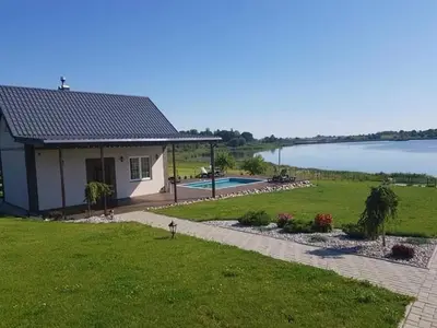 a small house with a view of a lake at Pirties namelis in Girininkai