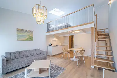 a living room with a couch and a table at Modern Loft Apartment with free parking No 1 in Marijampolė