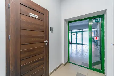a wooden door with a green frame in a room at Modern Loft Apartment with free parking No 1 in Marijampolė