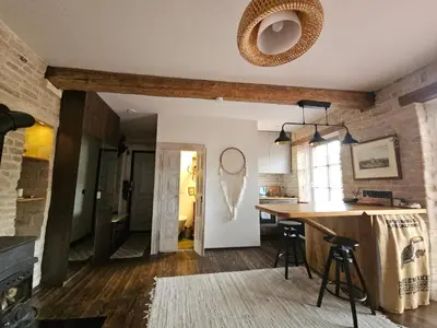 a kitchen with a counter and a bar in a room at Paupio Gertruda in Vilnius