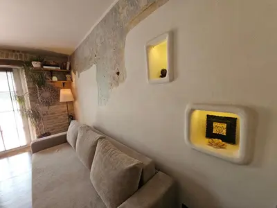a living room with a couch and a fireplace at Paupio Gertruda in Vilnius