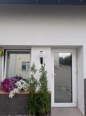 a front door of a house with flowers at Comfort Akacija Hotel in Vilnius