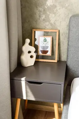 a side table with a picture and a vase on it at Karaliaus apartment in Kaunas