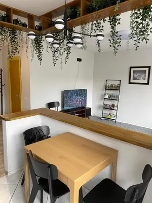 a dining room with a table and chairs at ROTUŠĖS g 23 APARTMENTS IN THE CITY CENTER BIRŽAI in Biržai
