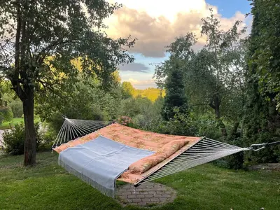 a hammock in the grass in a garden at Comfortable apartments - Nature, silence, coziness in Kėdainiai