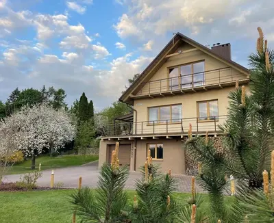 a house with a balcony on top of it at Comfortable apartments - Nature, silence, coziness in Kėdainiai