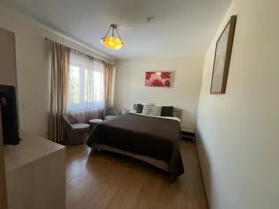 a bedroom with a black bed and a window at Pilaites svetingi namai in Vilnius