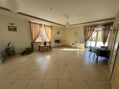 a living room with a large tile floor and windows at Pilaites svetingi namai in Vilnius