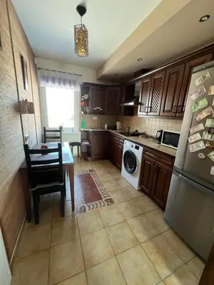 a kitchen with a table and a refrigerator at Pilaites svetingi namai in Vilnius