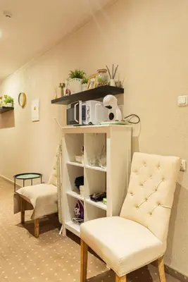 a room with two chairs and a book shelf at Inza Guest House in Druskininkai