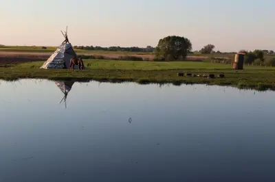 a small tent next to a body of water at Sveikatinimas kaime in Vilkaviškis