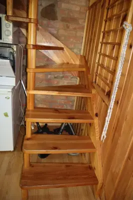 a set of wooden stairs in a house at Sveikatinimas kaime in Vilkaviškis