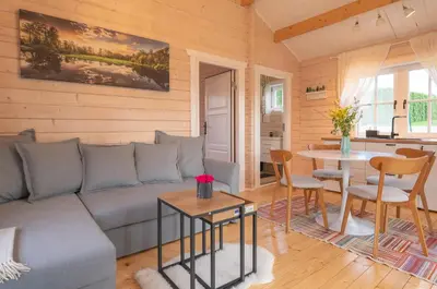 a living room with a couch and a table at Gandro lizdas in Lekėčiai