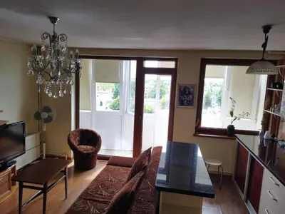 a living room with a couch and a table at Itaja Apartment 91 in Šiauliai