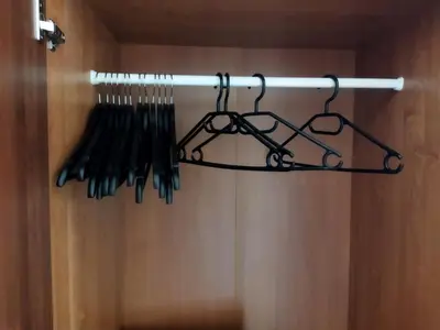a bunch of utensils are hanging on a rack at Itaja Apartment 91 in Šiauliai