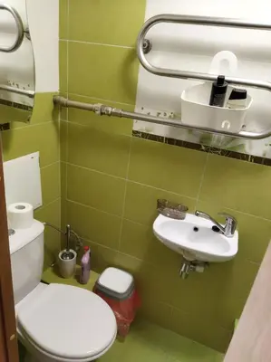 a bathroom with a toilet and a sink at Itaja Apartment 91 in Šiauliai
