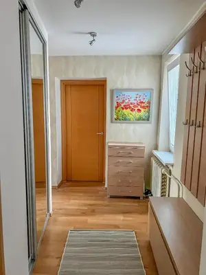 a hallway with a door and a dresser in a room at Lakeview Retreat in Vievis in Vievis