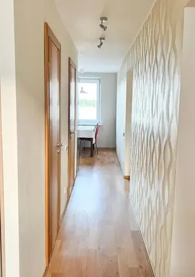 an empty hallway with a door and a table at Lakeview Retreat in Vievis in Vievis