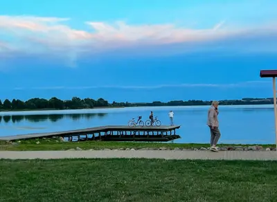 a man is standing on a dock near a lake at Lakeview Retreat in Vievis in Vievis