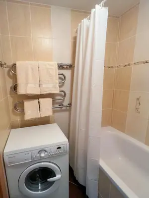 a bathroom with a washing machine and a shower at Lakeview Retreat in Vievis in Vievis