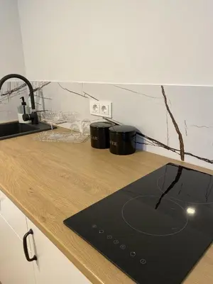a kitchen with a counter top with a laptop on it at Petro Apartamentai in Kačerginė