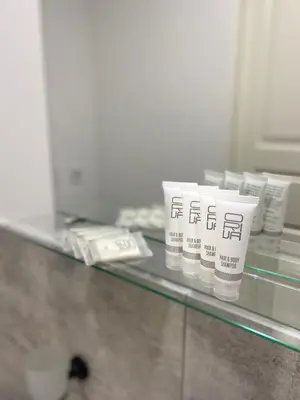 a glass counter with four cups on it at Petro Apartamentai in Kačerginė