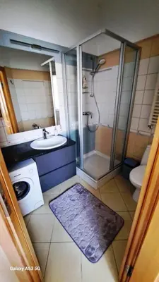 a bathroom with a shower and a sink and a toilet at KaunasInn in Kaunas