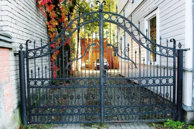 a black iron gate in front of a house at KaunasInn in Kaunas