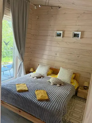 a bedroom with a bed with two towels on it at Obuoliu Sala OLAGA on the Apple Island in Gaylyunay