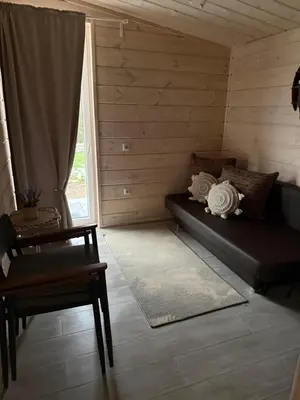 a room with a couch and a table and a window at Obuoliu Sala OLAGA on the Apple Island in Gaylyunay