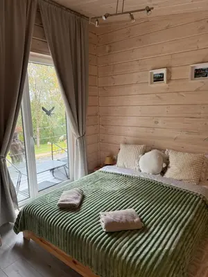 a bedroom with a bed with two towels on it at Obuoliu Sala OLAGA on the Apple Island in Gaylyunay