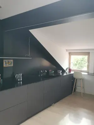a kitchen with a black counter top and a window at Charming Apartment in Kaunas Old Town with Balcony in Kaunas