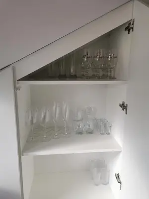 a bunch of glasses on a shelf in a room at Charming Apartment in Kaunas Old Town with Balcony in Kaunas