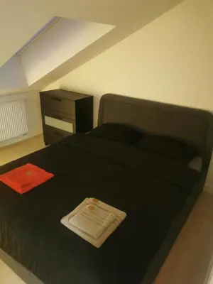 a bedroom with a black bed and a dresser at Charming Apartment in Kaunas Old Town with Balcony in Kaunas