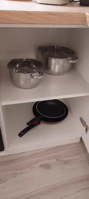 two pots and pans on a shelf in a kitchen at DIVA contactless check in & out in Šiauliai