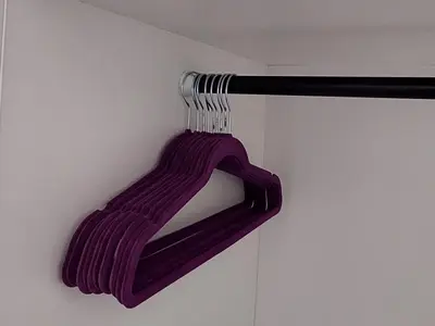 a purple scarf is hanging on a wall at DIVA contactless check in & out in Šiauliai