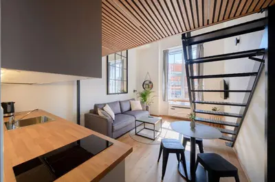 a living room with a couch and a table at Queen Barbora Central Lofts in Kaunas