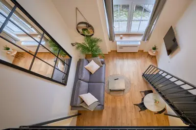 an overhead view of a living room with a couch and stairs at Queen Barbora Central Lofts in Kaunas