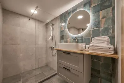 a bathroom with a sink and a mirror at Queen Barbora Central Lofts in Kaunas