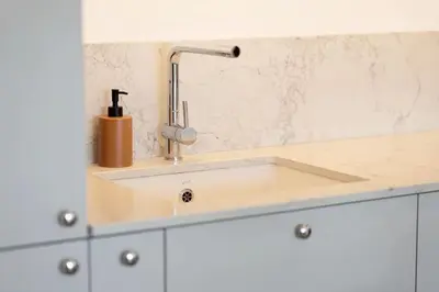 a kitchen counter with a sink and a faucet at 1bdr Apt w/Balcony, free Pkg in Vilnius