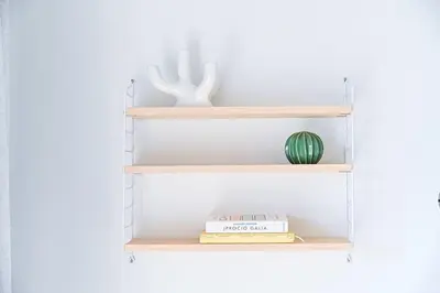 a glass shelf with a book and a vase at 1bdr Apt w/Balcony, free Pkg in Vilnius